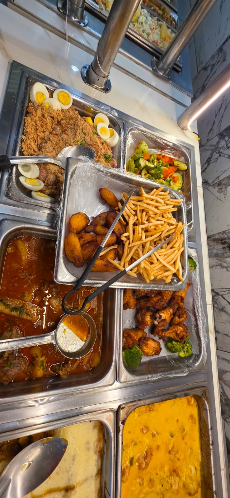 The Goianeiro buffet: farofa with eggs, fried plantains, fries, roast chicken and stews