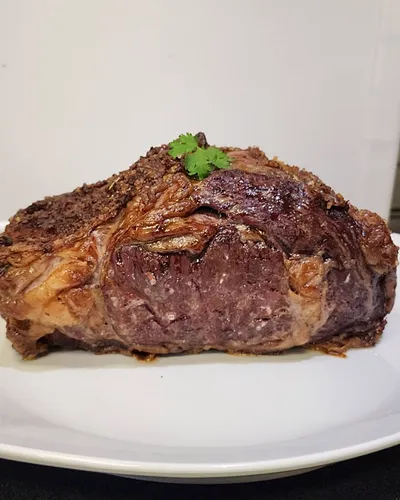 Roast beef with a crisp crust, garnished with cilantro