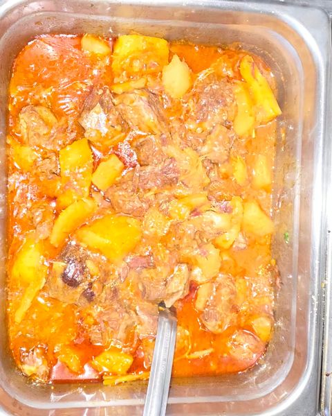 Tray of slow-cooked beef stew with potatoes