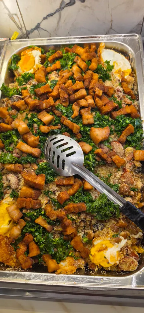 Feijão tropeiro with pork belly, greens and fried eggs