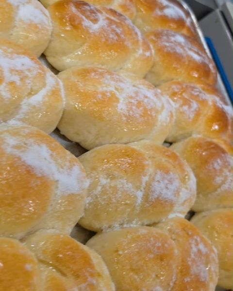 Tray of golden Brazilian bread rolls fresh from the oven