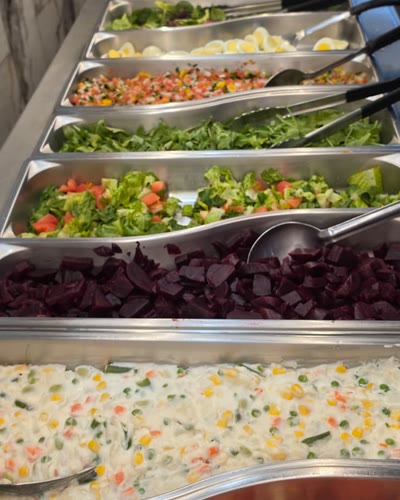 Salad bar: greens, boiled eggs, vinaigrette, beets, potato salad and tomatoes